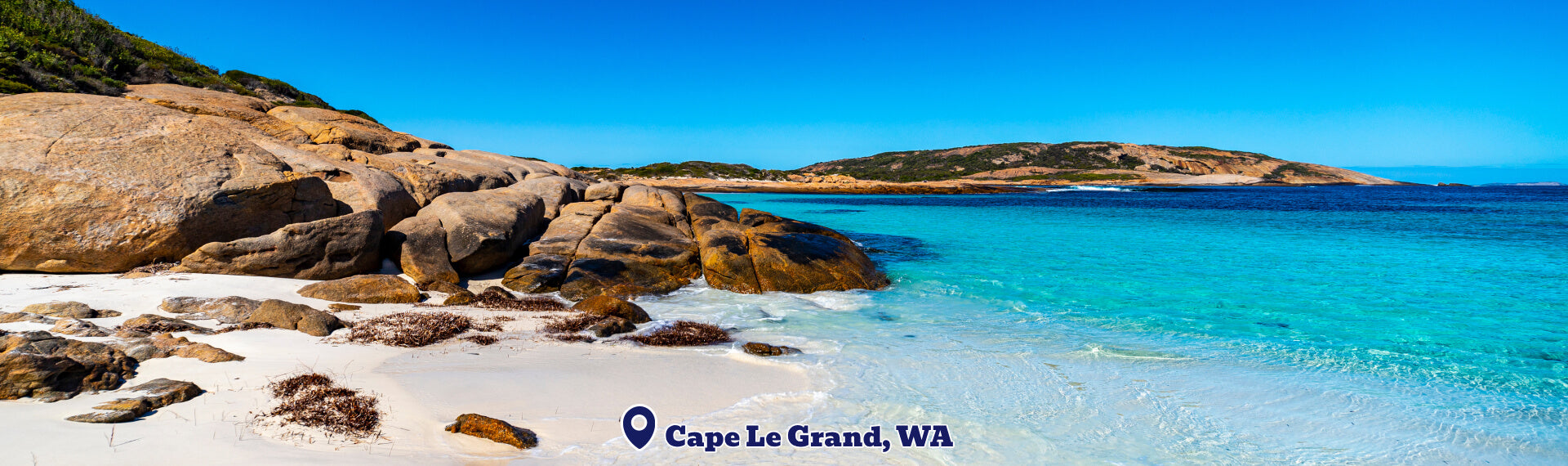 Beach scene with rocks and clear blue water at Cape Le Grand, WA