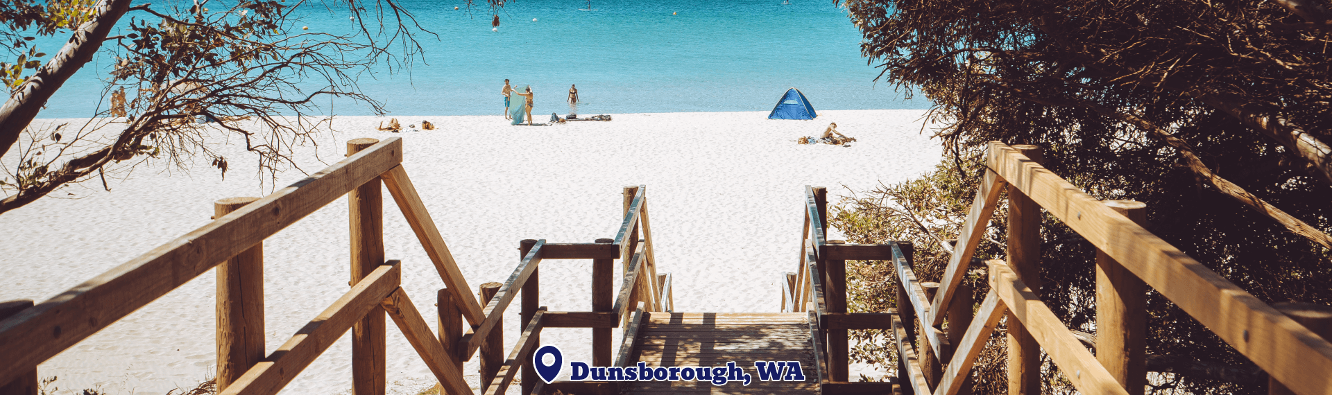 Wooden staircase leading to a sandy beach with people in the distance, featuring the text 'Dunsborough, WA'.